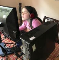 Farnborough school pupil enjoying home larning through a donated computer