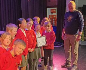 Cherrywood School Choir receieving their prize winning certificate from Lion President Steve Boast